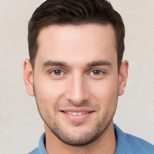 Joyful white young-adult male with short  brown hair and brown eyes