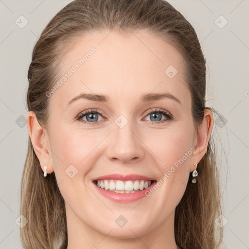 Joyful white young-adult female with long  brown hair and grey eyes