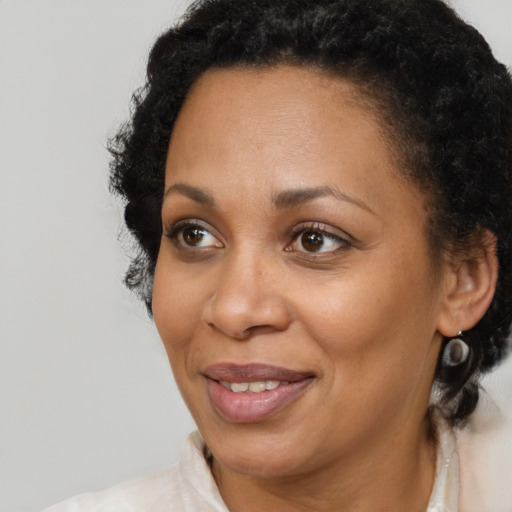 Joyful black adult female with short  brown hair and brown eyes