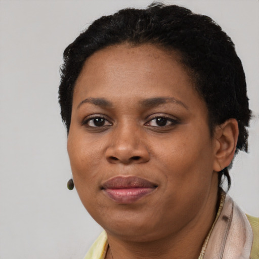 Joyful black adult female with short  black hair and brown eyes