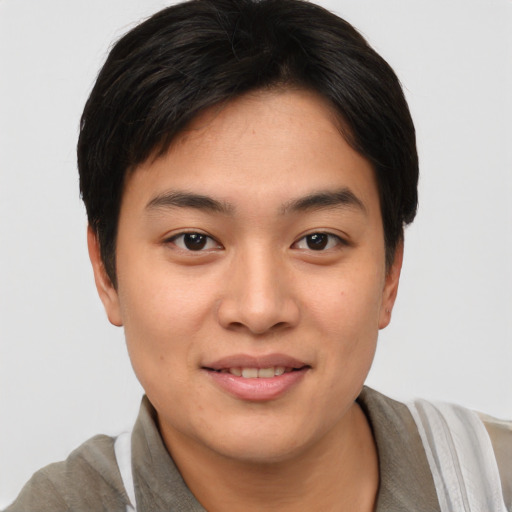 Joyful asian young-adult female with short  brown hair and brown eyes