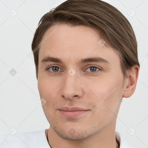 Joyful white young-adult male with short  brown hair and grey eyes