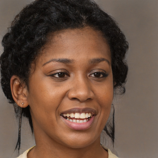 Joyful black young-adult female with medium  brown hair and brown eyes