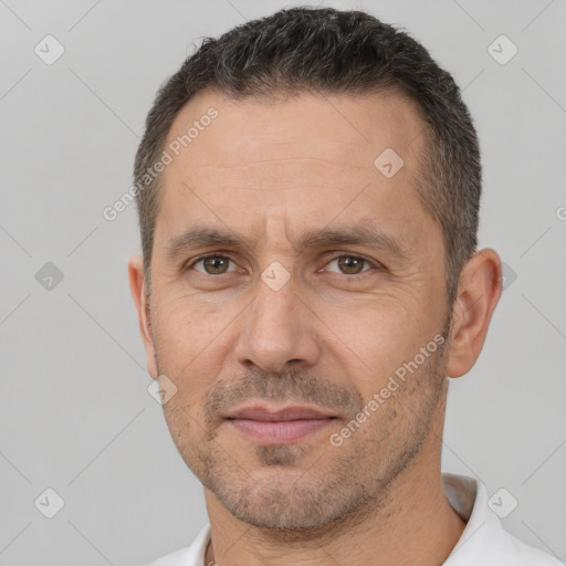 Joyful white adult male with short  brown hair and brown eyes