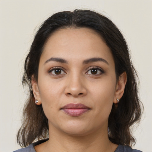 Joyful latino young-adult female with medium  brown hair and brown eyes