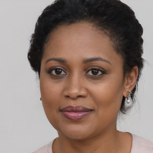 Joyful black young-adult female with medium  black hair and brown eyes