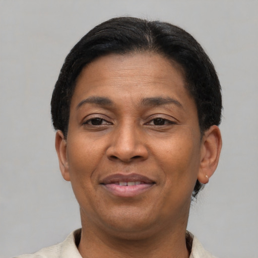 Joyful latino adult female with short  brown hair and brown eyes