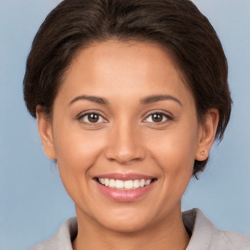 Joyful white young-adult female with medium  brown hair and brown eyes