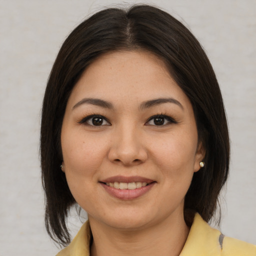 Joyful latino young-adult female with medium  brown hair and brown eyes