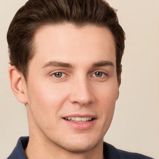 Joyful white young-adult male with short  brown hair and grey eyes