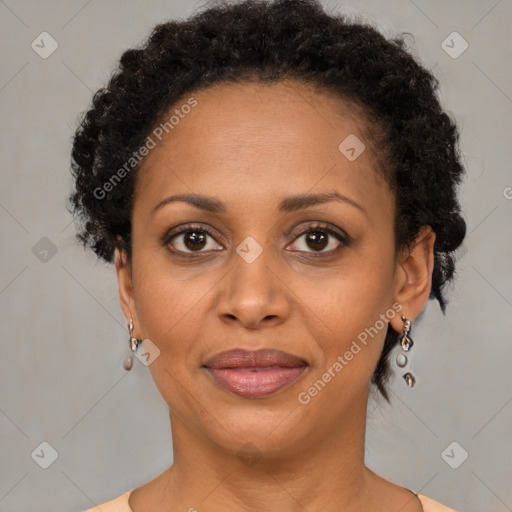 Joyful black adult female with short  brown hair and brown eyes