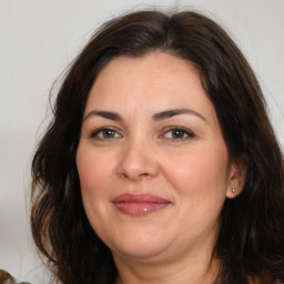 Joyful white adult female with medium  brown hair and brown eyes