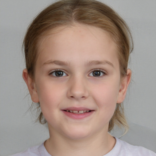 Joyful white child female with medium  brown hair and brown eyes