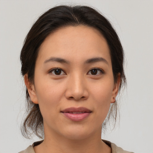 Joyful asian young-adult female with medium  brown hair and brown eyes