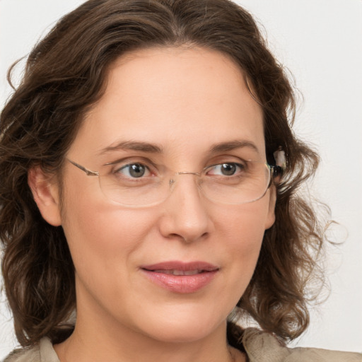 Joyful white adult female with medium  brown hair and green eyes