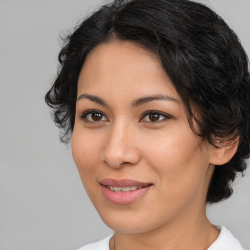Joyful latino young-adult female with medium  brown hair and brown eyes