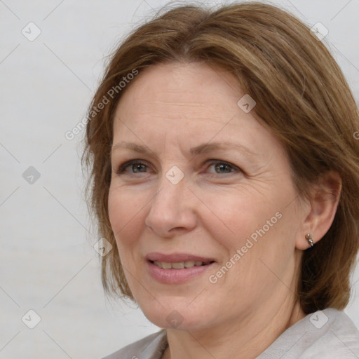 Joyful white adult female with medium  brown hair and brown eyes