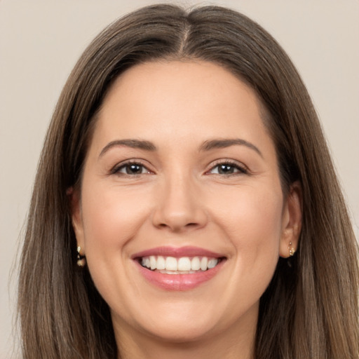 Joyful white young-adult female with long  brown hair and brown eyes