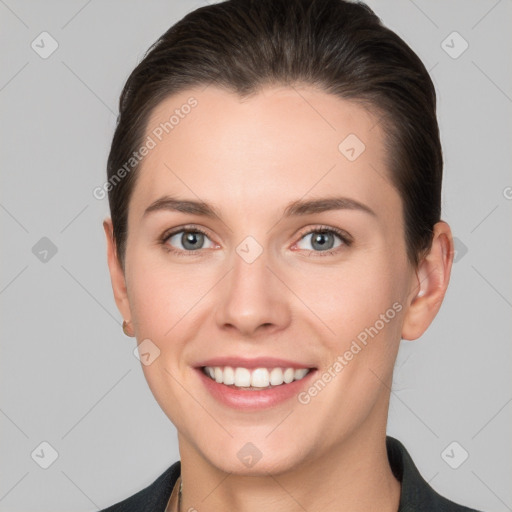 Joyful white young-adult female with short  brown hair and grey eyes