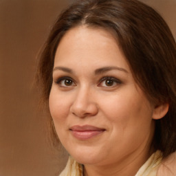 Joyful white adult female with long  brown hair and brown eyes