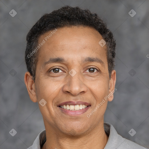 Joyful latino adult male with short  brown hair and brown eyes