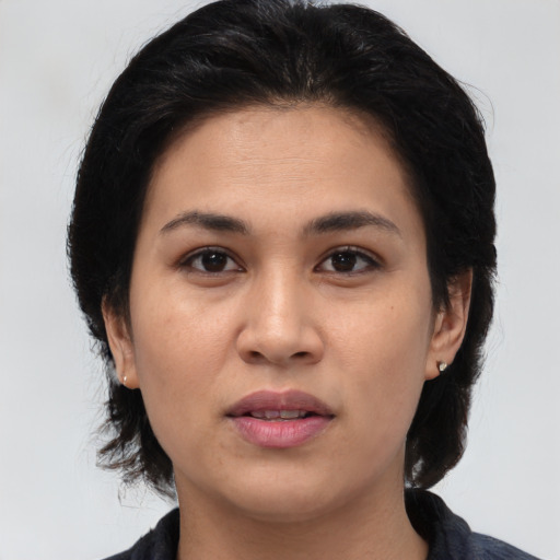 Joyful latino young-adult female with medium  black hair and brown eyes