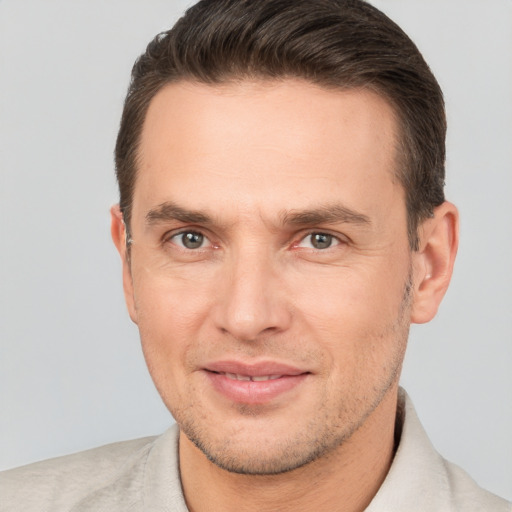 Joyful white adult male with short  brown hair and brown eyes