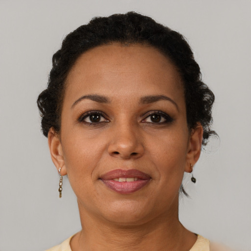 Joyful black adult female with short  brown hair and brown eyes