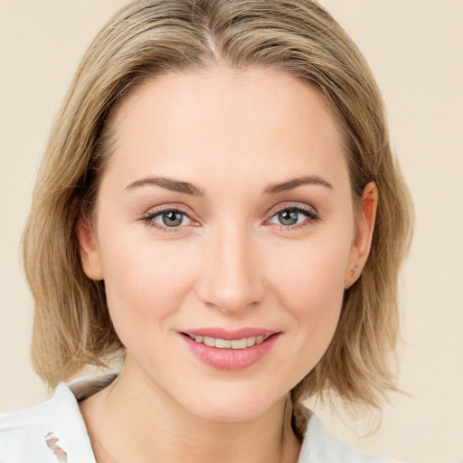 Joyful white young-adult female with medium  brown hair and blue eyes