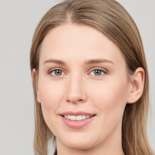 Joyful white young-adult female with long  brown hair and grey eyes