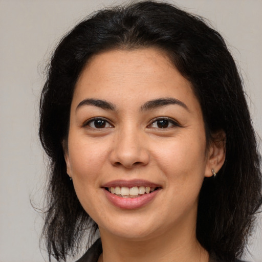 Joyful latino young-adult female with medium  brown hair and brown eyes