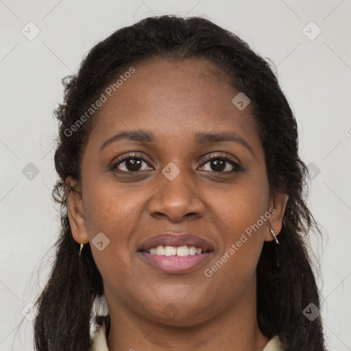 Joyful black young-adult female with long  brown hair and brown eyes