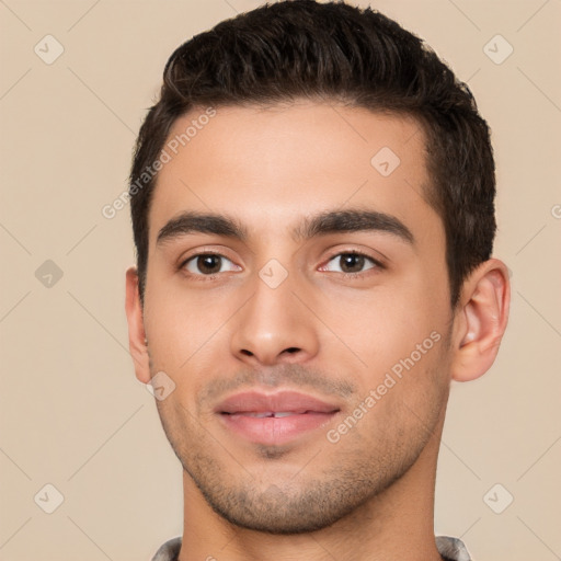 Joyful white young-adult male with short  black hair and brown eyes