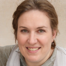 Joyful white young-adult female with medium  brown hair and blue eyes