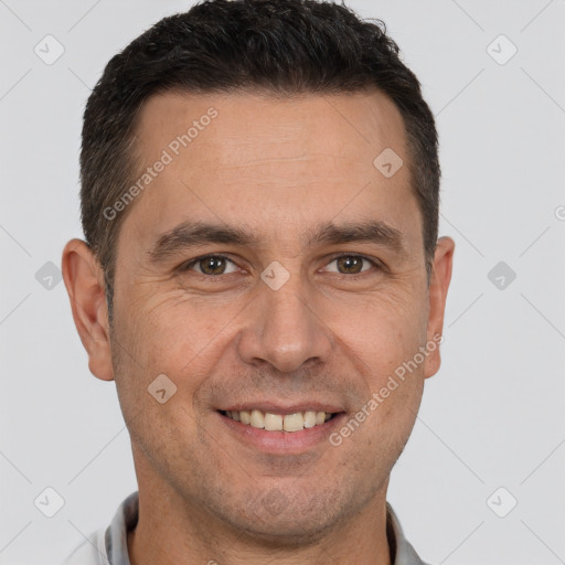 Joyful white adult male with short  brown hair and brown eyes