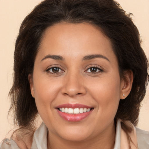 Joyful white young-adult female with long  brown hair and brown eyes