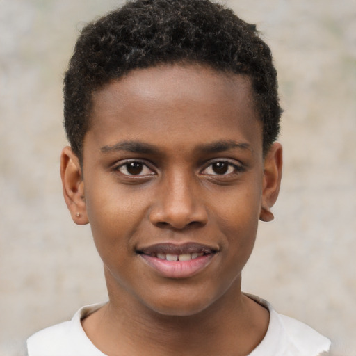 Joyful black child male with short  brown hair and brown eyes