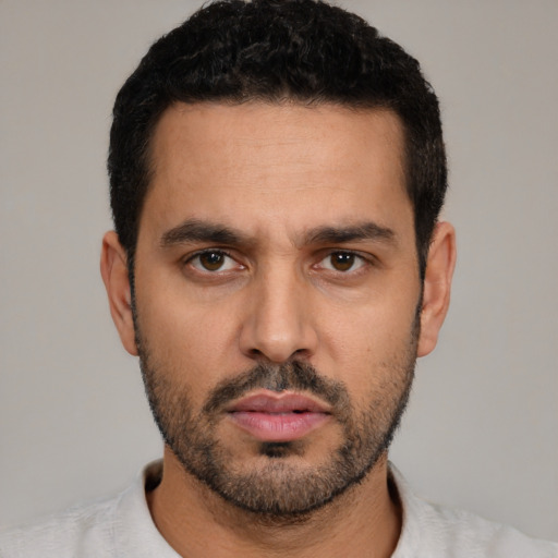 Neutral latino young-adult male with short  black hair and brown eyes