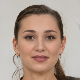 Joyful white young-adult female with medium  brown hair and grey eyes