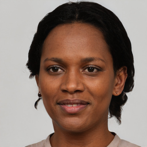 Joyful black adult female with short  black hair and brown eyes
