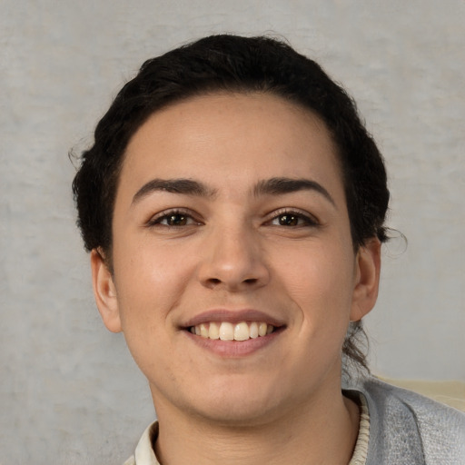 Joyful white young-adult female with short  brown hair and brown eyes