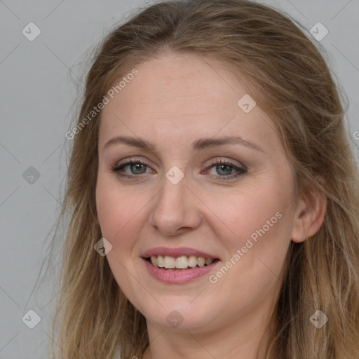 Joyful white young-adult female with long  brown hair and blue eyes