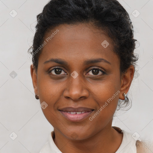 Joyful black young-adult female with short  brown hair and brown eyes