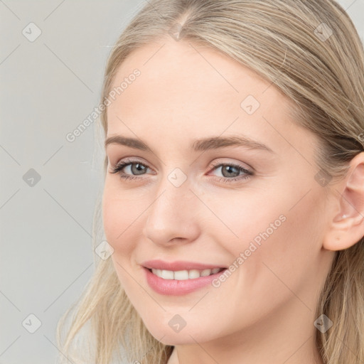 Joyful white young-adult female with long  brown hair and blue eyes