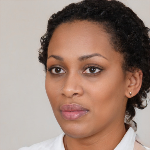 Neutral black young-adult female with medium  brown hair and brown eyes