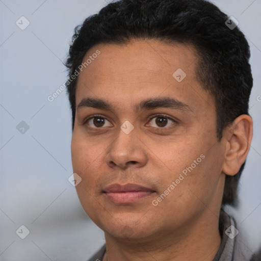 Joyful white young-adult male with short  black hair and brown eyes