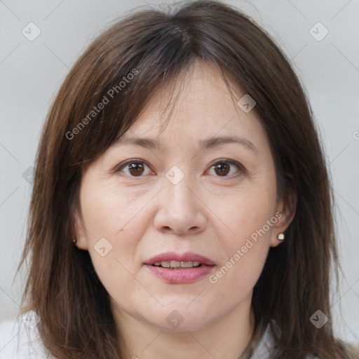 Joyful white adult female with long  brown hair and brown eyes