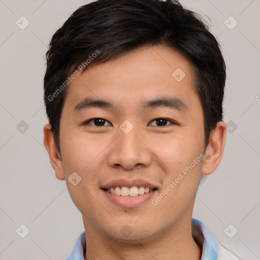 Joyful asian young-adult male with short  brown hair and brown eyes