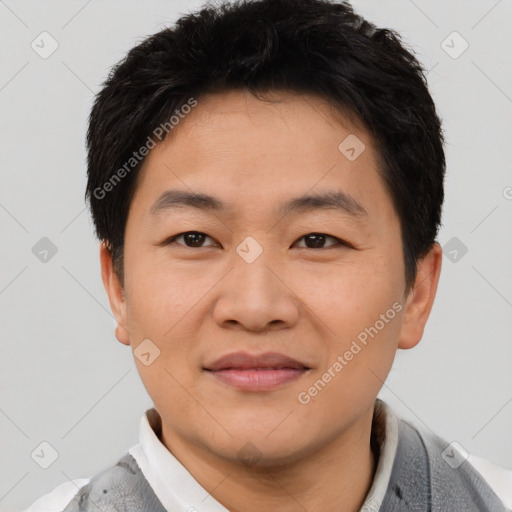 Joyful asian young-adult male with short  brown hair and brown eyes