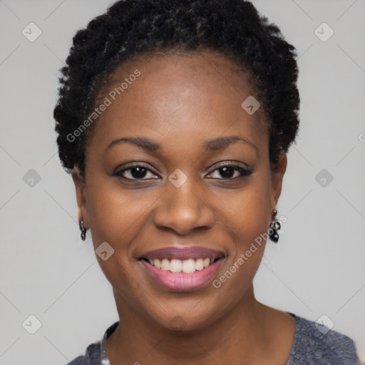 Joyful black young-adult female with short  black hair and brown eyes